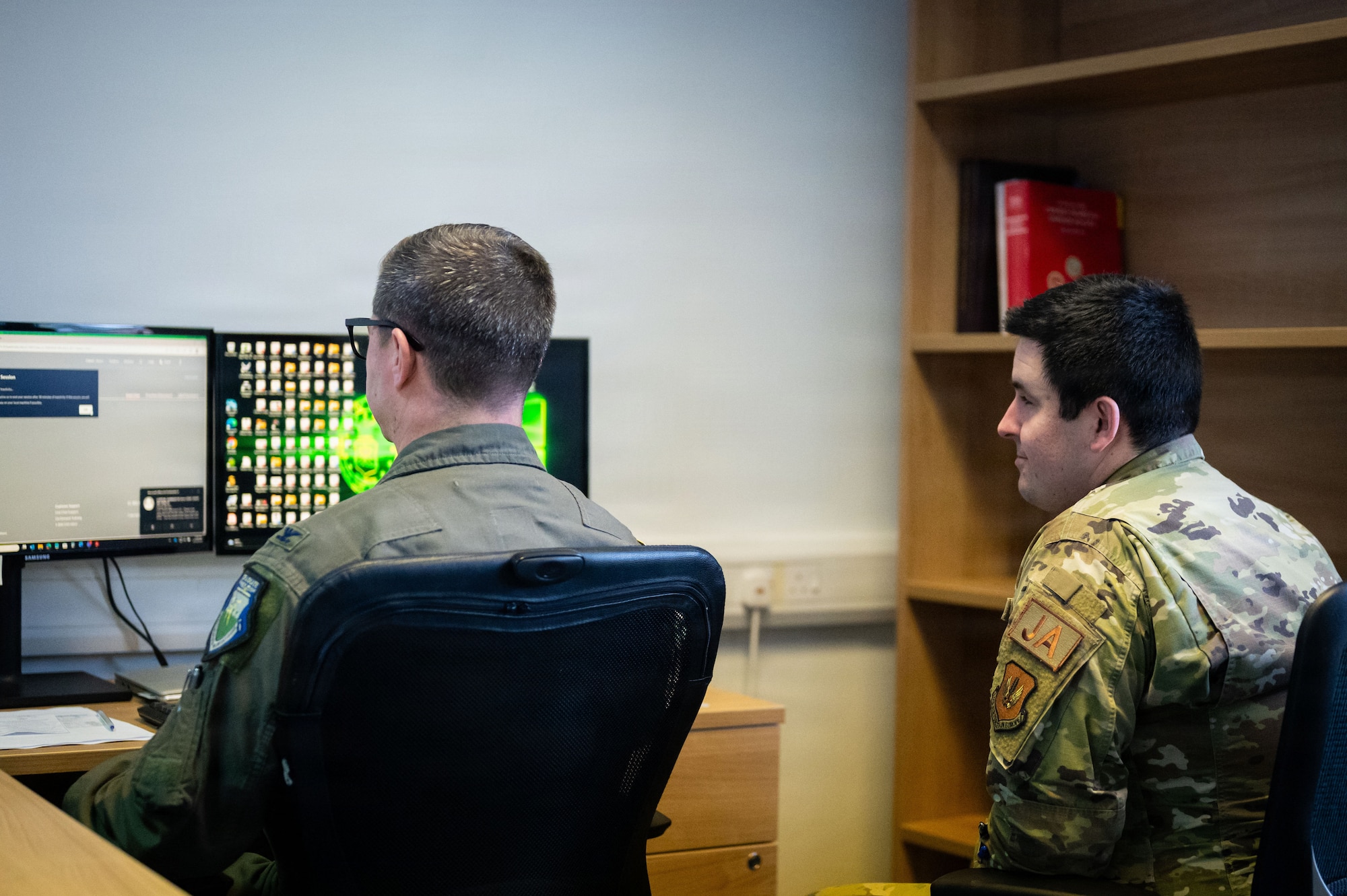 U.S. Air Force Senior Airman Mason Walch, right, 100th Air Refueling Wing civil law paralegal, briefs Col. Steven Byrum, 100th ARW commander, during a day in the life integration at RAF Mildenhall, England, Feb. 23, 2026.