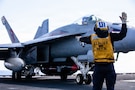 A U.S. Sailor signals to an F/A-18E Super Hornet aircraft, attached to Strike Fighter Squadron 31, on the flight deck of the world's largest aircraft carrier, USS Gerald R. Ford (CVN 78), while operating in support of Operation Epic Fury in the Eastern Mediterranean Sea, March 2, 2026. (U.S. Navy photo)