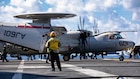 A U.S. Sailor observes an E-2D Hawkeye, attached to Airborne Command and Control Squadron 124, taxi on the flight deck of the world’s largest aircraft carrier, USS Gerald R. Ford (CVN 78), while operating in support of Operation Epic Fury in the Eastern Mediterranean Sea, March 2, 2026. (U.S. Navy photo)