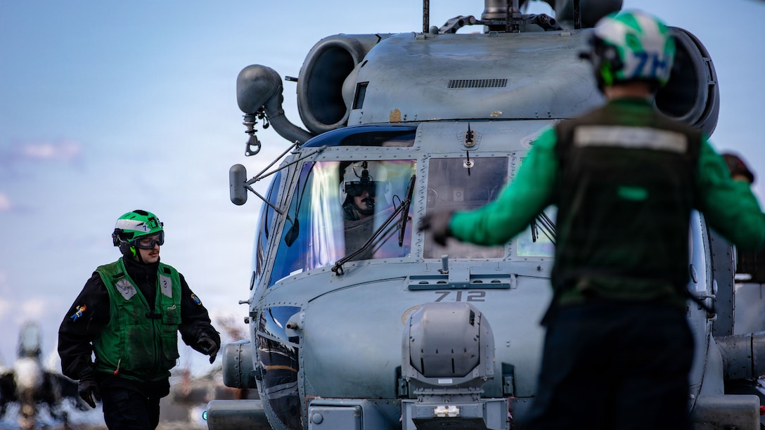 A U.S. Sailor inspects an MH-60R Sea Hawk helicopter, attached to Helicopter Maritime Strike Squadron 70, after landing on the flight deck of the world's largest aircraft carrier, USS Gerald R. Ford (CVN 78), while operating in support of Operation Epic Fury in the Eastern Mediterranean Sea, March 2, 2026. (U.S. Navy photo)