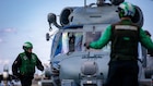 A U.S. Sailor inspects an MH-60R Sea Hawk helicopter, attached to Helicopter Maritime Strike Squadron 70, after landing on the flight deck of the world's largest aircraft carrier, USS Gerald R. Ford (CVN 78), while operating in support of Operation Epic Fury in the Eastern Mediterranean Sea, March 2, 2026. (U.S. Navy photo)