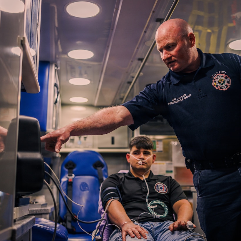 Jay LaLond, a firefighter/paramedic with Quantico Fire and Emergency Services Station 31, right, checks vitals while giving a demonstration using the LifePak 35 cardiac monitor/defibrillator at QF&ES Station 31 on Marine Corps Base Quantico, Feb. 11, 2026. The LifePak 35 is an advanced clinical decision support tool designed to promote confident cardiac care and deliver in demanding environments. Station 31 recently integrated these devices into their protocol over the LifePak 15 for their additional capabilities and features along with extensive training to provide maximum safety to service members and families aboard MCB Quantico. (U.S. Marine Corps photo by Cpl. Braydon Rogers)
