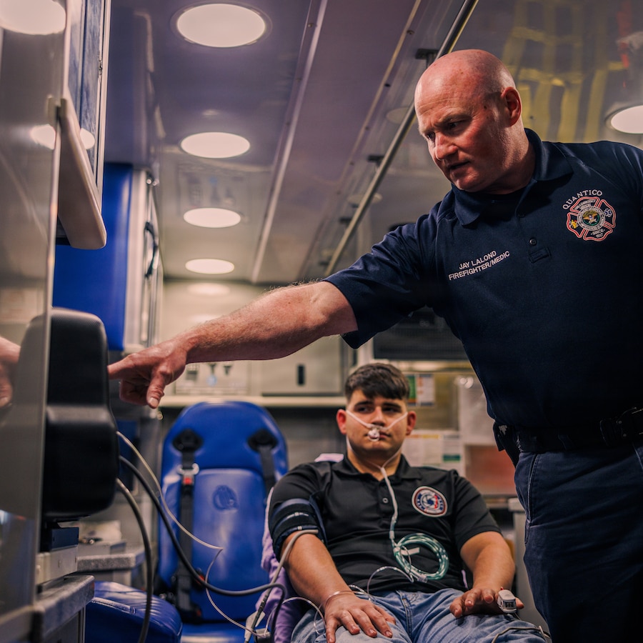 Jay LaLond, a firefighter/paramedic with Quantico Fire and Emergency Services Station 31, right, checks vitals while giving a demonstration using the LifePak 35 cardiac monitor/defibrillator at QF&ES Station 31 on Marine Corps Base Quantico, Feb. 11, 2026. The LifePak 35 is an advanced clinical decision support tool designed to promote confident cardiac care and deliver in demanding environments. Station 31 recently integrated these devices into their protocol over the LifePak 15 for their additional capabilities and features along with extensive training to provide maximum safety to service members and families aboard MCB Quantico. (U.S. Marine Corps photo by Cpl. Braydon Rogers)