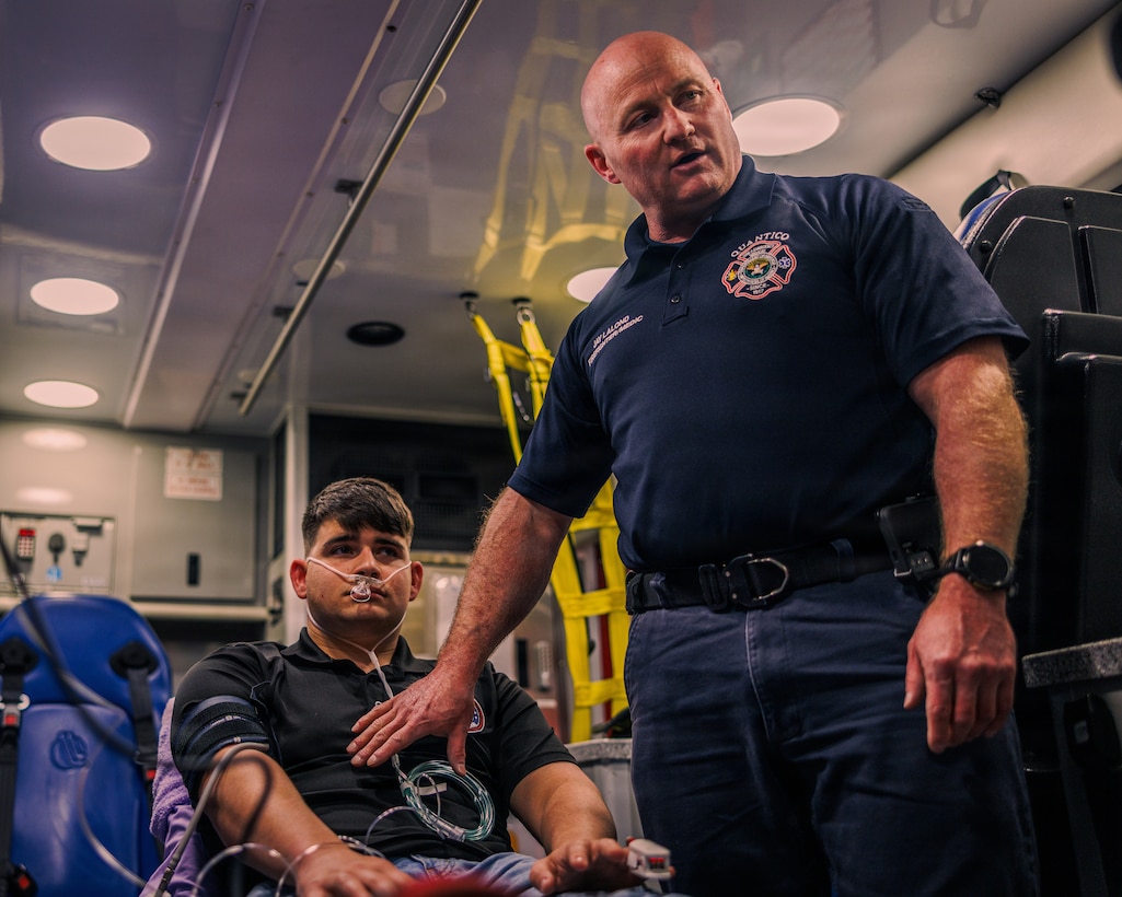 Jay LaLond, a firefighter/paramedic with Quantico Fire and Emergency Services Station 31, right, explains medical procedures while giving a demonstration using the LifePak 35 cardiac monitor/defibrillator at QF&ES Station 31 on Marine Corps Base Quantico, Feb. 11, 2026. The LifePak 35 is an advanced clinical decision support tool designed to promote confident cardiac care and deliver in demanding environments. Station 31 recently integrated these devices into their protocol over the LifePak 15 for their additional capabilities and features along with extensive training to provide maximum safety to service members and families aboard MCB Quantico. (U.S. Marine Corps photo by Cpl. Braydon Rogers)