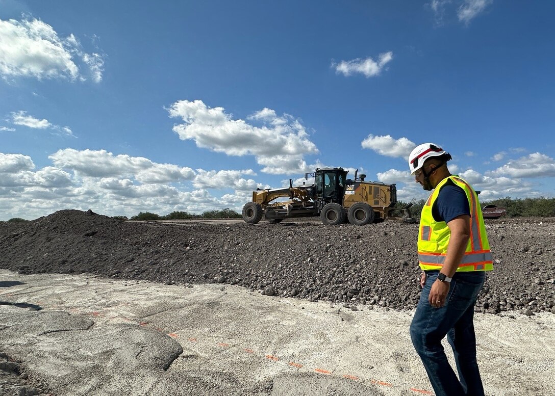 Larbi Kandil, chief of Asset Management for the U.S. Army Corps of Engineers Jacksonville District and the FY25 February team lead for the Jacksonville District Leadership Development Program, walks a prepared construction surface as heavy equipment operates in the background during a February 2025 project site visit in Southern Florida. Kandil organized site visits and field coordination to ensure LDP members gained firsthand insight into construction sequencing, safety oversight and civil works execution aligned with the district’s everglades restoration framework and water management mission. (U.S. Army Corps of Engineers photo by Public Affairs Specialist Misty Cunningham)