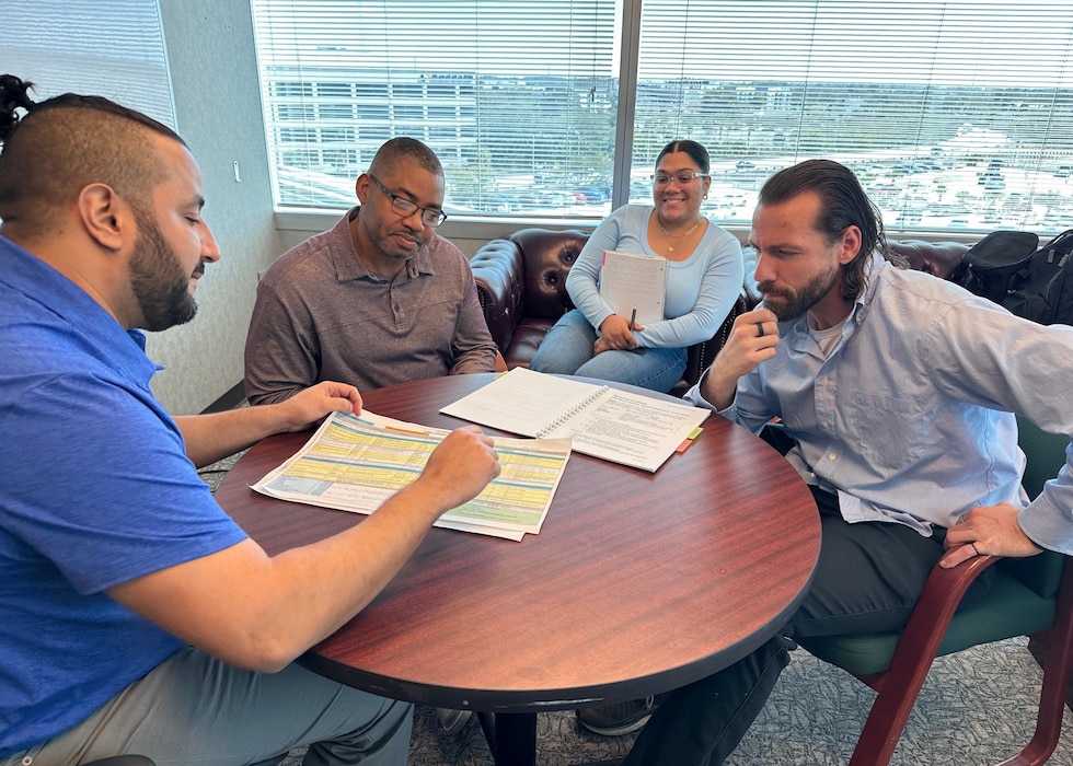 Larbi Kandil, chief of Asset Management for the U.S. Army Corps of Engineers Jacksonville District, meets with members of his team to review project timelines, discuss upcoming deadlines and outline plans of action. Kandil regularly engages his staff in collaborative planning sessions to ensure priorities are aligned, resources are effectively managed, and mission requirements are executed with precision and accountability. (U.S. Army Corps of Engineers photo by Misty Cunningham)