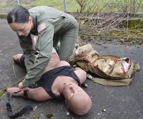 Tourniquet treatment … Under the watchful gaze of Navy Medicine Readiness Training Command Bremerton Tactical Combat Casualty Care instructors, 315th Aeromedical Evacuation Squadron personnel hone their medical response skills in treating traumatic injuries on the field of battle. The visiting Air Force personnel from Charleston Air Force Base, South Carolina, received intensive didactic module training before undergoing and completing their educational effort with actual hands-on application in the field. Amidst a mock firefight exploding around them, faux patient screams and bellowing demands from instructors, the 315th team were tested on conducting – with timely urgency - primary and secondary assessments, casualty movement, airway management, hemorrhage control, chest needle decompression, applying splinting and pressure dressings, and more (Official Navy photo by Douglas H Stutz, NHB/NMRTC Bremerton public affairs officer).