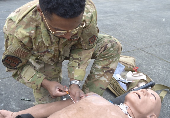 A saving stick...315th Aeromedical Evacuation Squadron personnel hone their medical response skills in treating traumatic injuries on the field of battle. The visiting Air Force personnel from Charleston Air Force Base, South Carolina, received intensive didactic module training before undergoing and completing their educational effort with actual hands-on application in the field. Amidst a mock firefight exploding around them, faux patient screams and bellowing demands from instructors, the 315th team were tested on conducting – with timely urgency - primary and secondary assessments, casualty movement, airway management, hemorrhage control, chest needle decompression, applying splinting and pressure dressings, and more (Official Navy photo by Douglas H Stutz, NHB/NMRTC Bremerton public affairs officer).