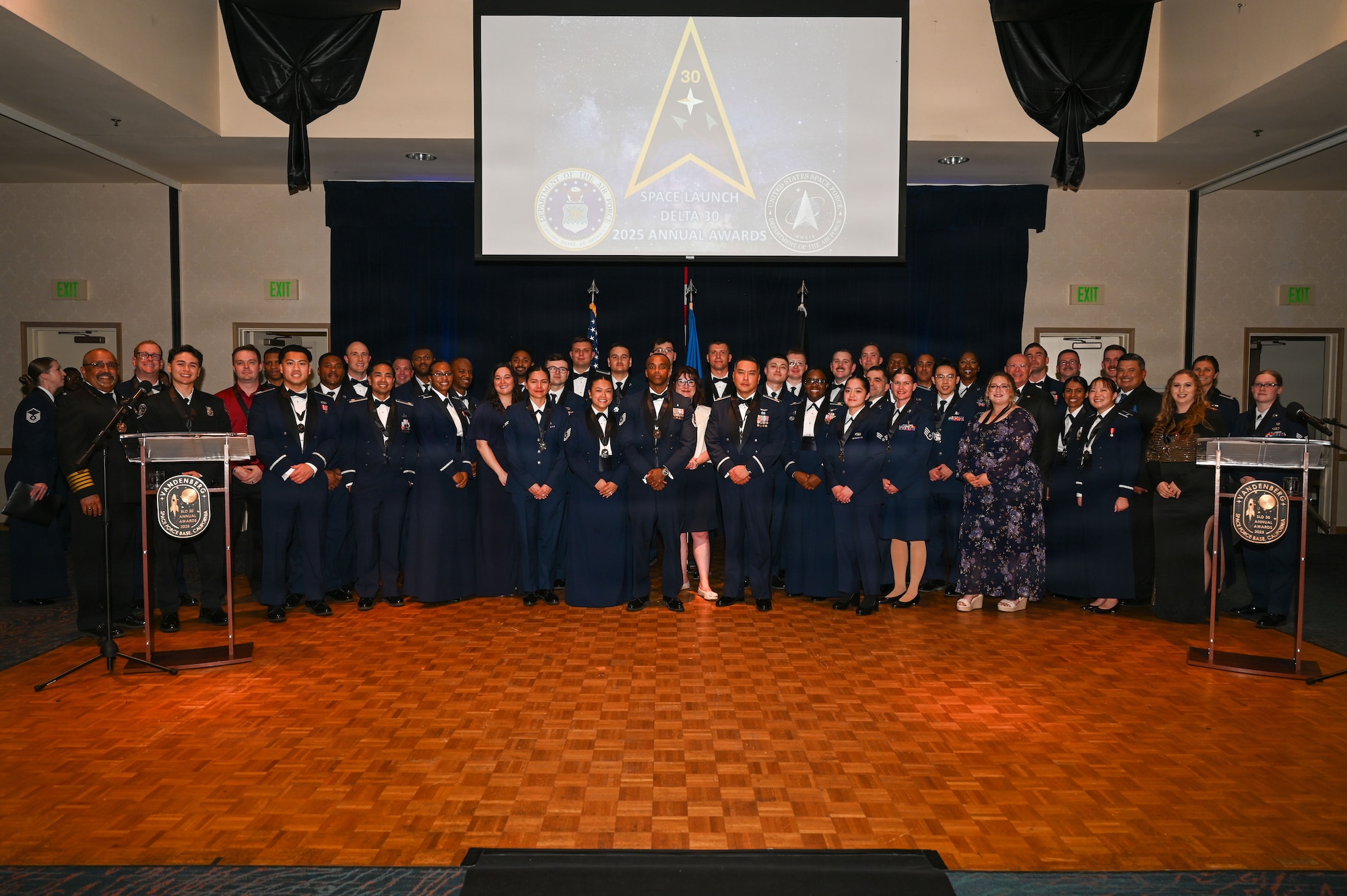 a group of people stand on a stage