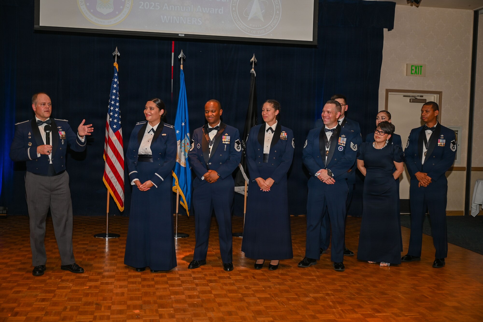 a group of people stand on a stage