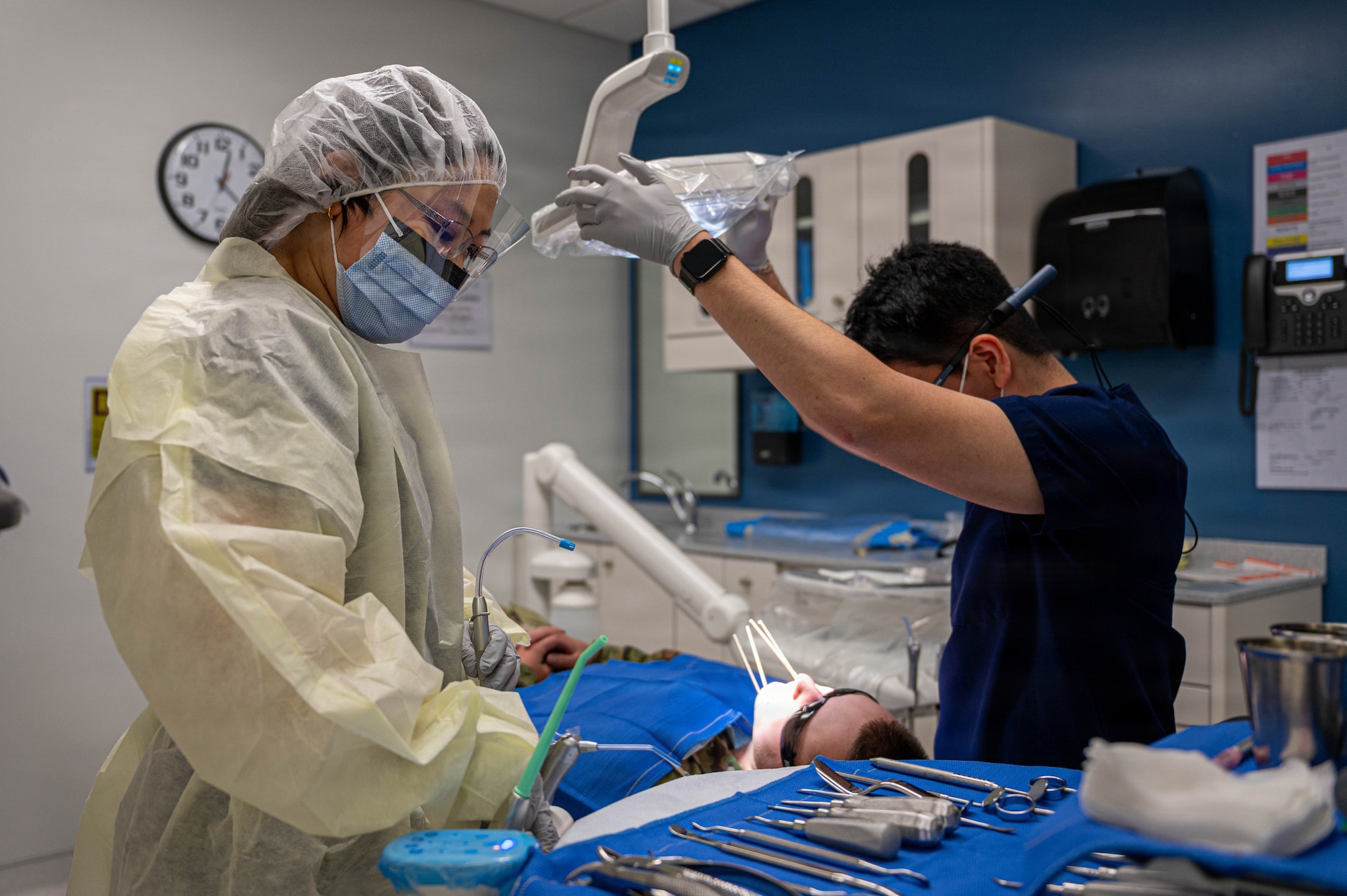 Dental assistant student assists Dentist with tooth extraction.