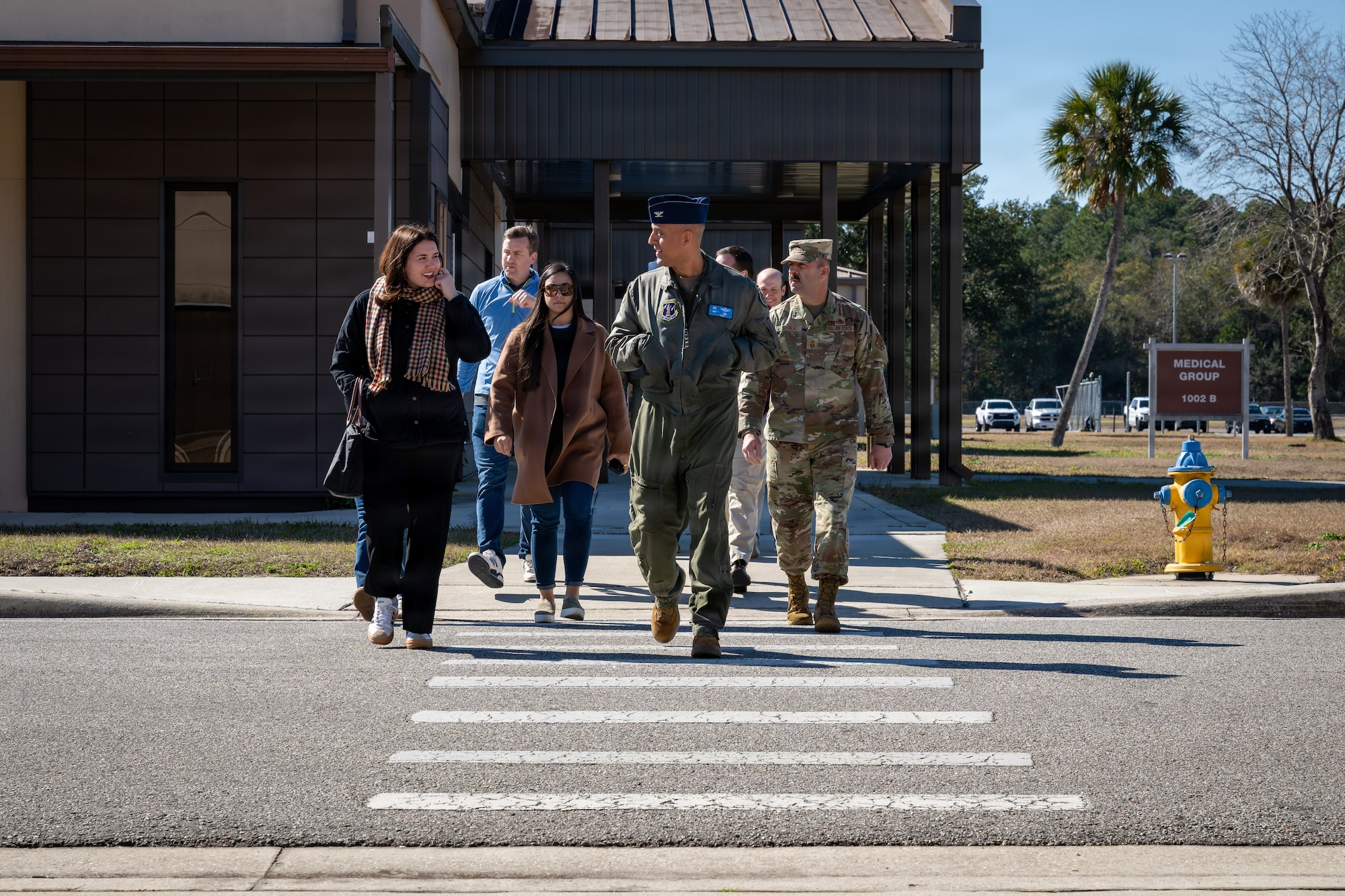 Col. Mansour Elhihi, center, commander of the Florida Air National Guard’s 125th Fighter Wing, along with U.S. Air Force Chief Master Sgt. William Ryals III, right, command chief, 125th Fighter Wing, walk with congressional staff delegates at Jacksonville Air National Guard Base, Florida.
