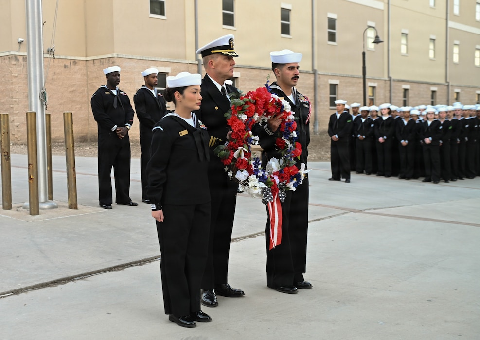 U.S. Navy Capt. Richard Lawrence, center, commanding officer of the Navy Medicine Training Support Command, along with Hospital Corpsman Second Class Elisa Tate and Hospital Corpsman Second Class Christian Garcia, present the wreath during a memorial ceremony held for Hospital Corpsman Third Class John T. Fralish at Joint Base San Antonio-Fort Sam Houston, Texas, Feb. 6, 2026. This year marks the 20th anniversary of Fralish’s passing during the War on Terror. (U.S. Navy photo by Mass Communication Specialist Seaman Apprentice Christine Walters)