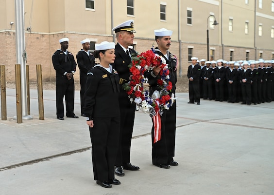 U.S. Navy Capt. Richard Lawrence, center, commanding officer of the Navy Medicine Training Support Command, along with Hospital Corpsman Second Class Elisa Tate and Hospital Corpsman Second Class Christian Garcia, present the wreath during a memorial ceremony held for Hospital Corpsman Third Class John T. Fralish at Joint Base San Antonio-Fort Sam Houston, Texas, Feb. 6, 2026. This year marks the 20th anniversary of Fralish’s passing during the War on Terror. (U.S. Navy photo by Mass Communication Specialist Seaman Apprentice Christine Walters)