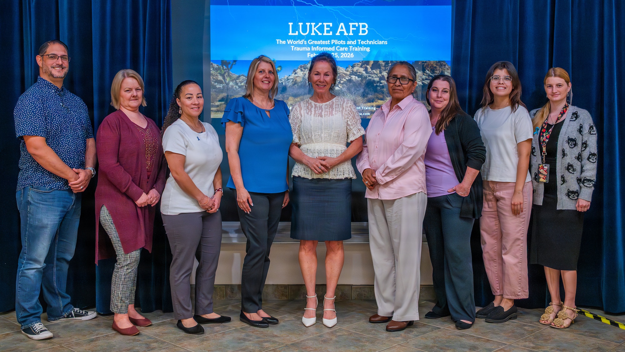 Annemarie du LeBohn, human development trainer and resilience expert, poses for a photo with two Sexual Assault Prevention and Response teams after a post-traumatic stress disorder and resiliency training on base, Feb. 25, 2026, at Luke Air Force Base, Arizona.