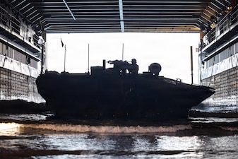 A U.S. Marine Corps amphibious combat vehicle, with Battalion Landing Team 3/5, 11th Marine Expeditionary Unit, docks on Whidbey Island-class dock landing ship USS Comstock (LSD 45) in the Pacific Ocean, Feb. 25, 2026. The 11th MEU is currently underway aboard the Boxer Amphibious Ready Group in the U.S. 3rd Fleet area of operations conducting integrated training that enhances lethality and warfighting readiness. (U.S. Marine Corps photo by Sgt. Trent A. Henry)