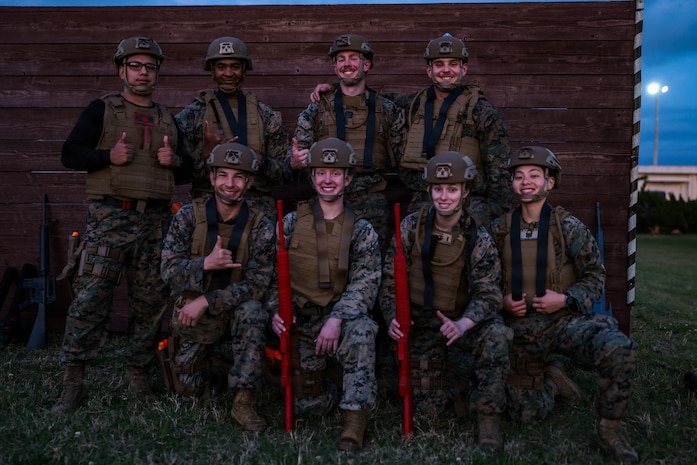 U.S. Marines with 5th Air Naval Gunfire Liaison Company, III Marine Expeditionary Force Information Group, and 9th Engineer Support Battalion, 3rd Marine Logistics Group, pose for a group photo a during Marine Corps Martial Arts Program black belt culminating event at Camp Hansen, Okinawa, Japan, Feb. 26, 2026.