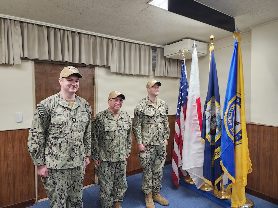 Left to right, Lt. Cmdr. Conor L. McNamara, incoming officer in charge (OIC), Military Sealift Command (MSC) Ship Support Unit (SSU) Japan; Capt. David L. Reyes, commodore, MSC Far East; and Lt. Cmdr. Shawn T. Tagan, outgoing OIC, MSC SSU Japan; stand at attention during a Change-of-Charge ceremony at Yokohama North Dock, Japan, March 2, 2026.