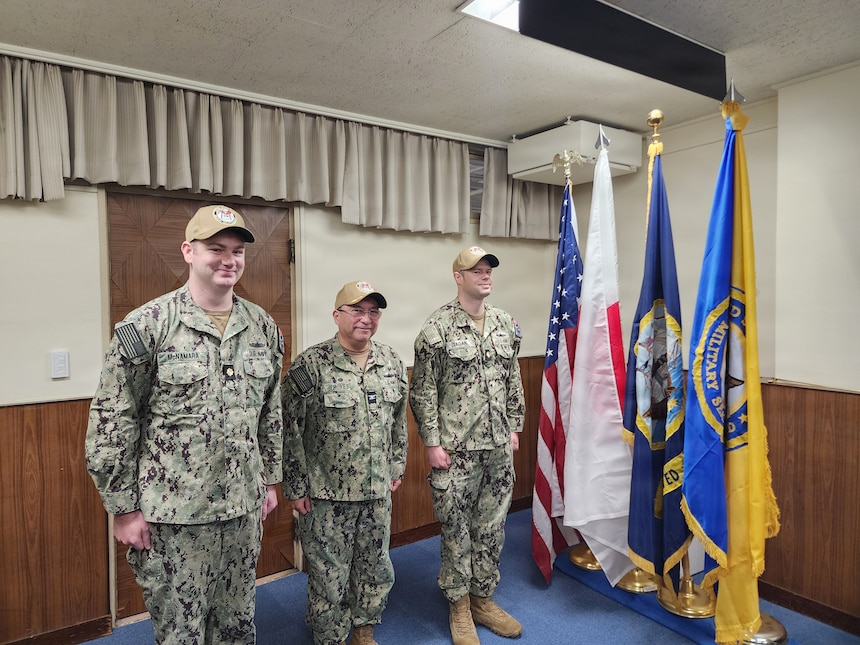 Left to right, Lt. Cmdr. Conor L. McNamara, incoming officer in charge (OIC), Military Sealift Command (MSC) Ship Support Unit (SSU) Japan; Capt. David L. Reyes, commodore, MSC Far East; and Lt. Cmdr. Shawn T. Tagan, outgoing OIC, MSC SSU Japan; stand at attention during a Change-of-Charge ceremony at Yokohama North Dock, Japan, March 2, 2026.
