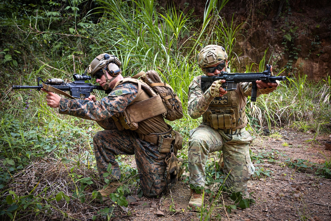 U.S. Marine Corps Lance Cpl. Peter D. Deluke, left, a combat engineer with 2nd Combat Engineer Battalion, 2nd Marine Division, kneels alongside Cabo Segundo Abdiel Zuñiga, a member of the Infantería de Marina, Servicio Nacional Aeronaval de Panamá, for a photo after the conclusion of a live-fire fire team attack range at Camp Cerro Tigre, Panama, Feb. 19, 2026. The training, conducted as part of Panamanian Partnership 26, enhanced interoperability and shared capabilities by enabling U.S. Marines with 2nd CEB to train alongside Panamanian security institutions in a combined training environment. (U.S. Marine Corps photo by Sgt. Antonino Mazzamuto)