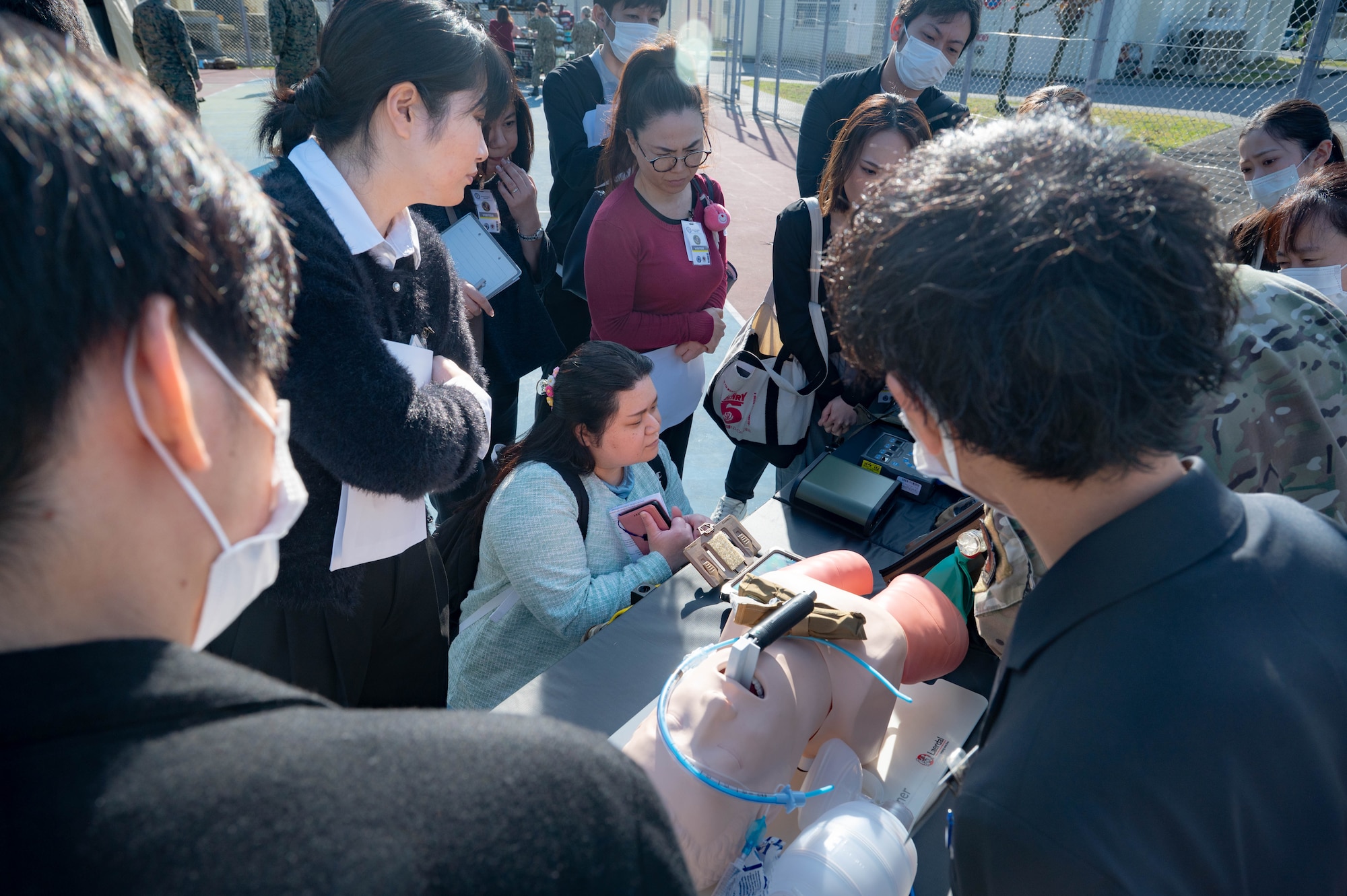 A special forces member instructs local japanese healthcare proffessionals