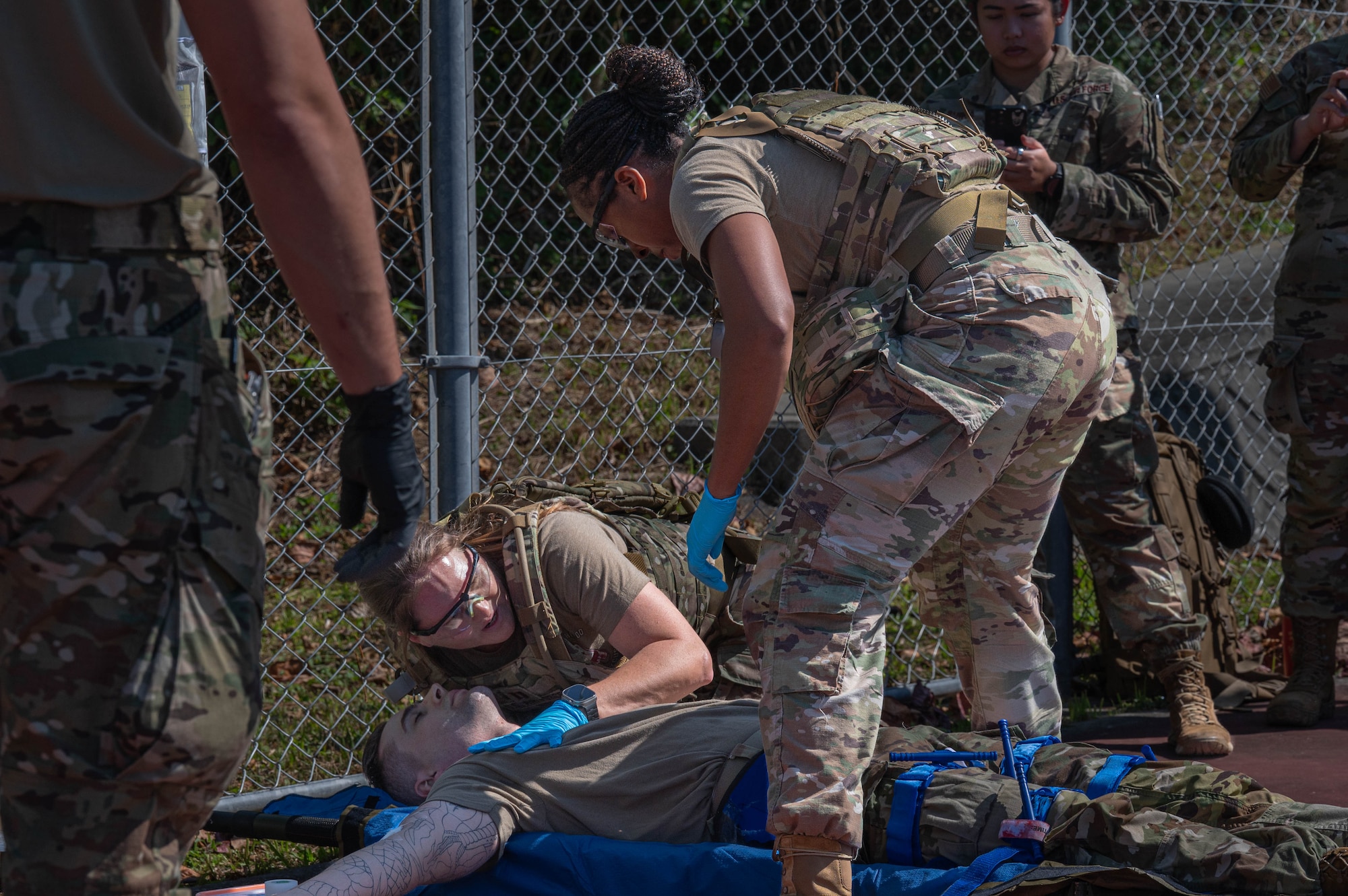 Two nurses listen for vitals of a patient