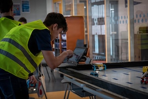 A student looks at a laptop.