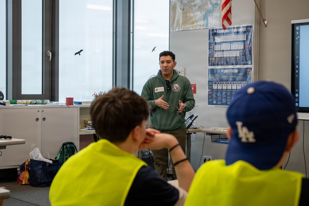 A man talks to a group of middle school students.