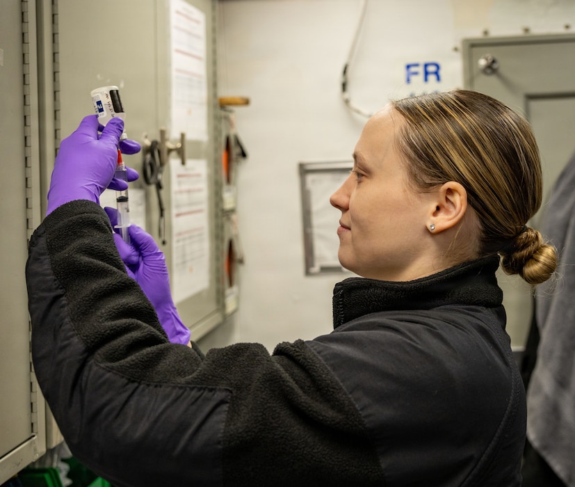 260226-N-EK577-1016 Hospital Corpsman 2nd Class Katherine Baudino prepares medicine aboard the Nimitz-class aircraft carrier USS George H.W. Bush (CVN 77) in the Atlantic Ocean, Feb. 26, 2026. The George H.W. Bush Carrier Strike Group is at sea training as an integrated war fighting team. Composite Training Unit Exercise (COMPTUEX) is the Joint Force’s most complex integrated training event and prepares naval task forces for sustained high-end Joint and combined combat. Integrated naval training provides combatant commanders and America’s civilian leaders highly capable forces that deter adversaries, underpin American security and economic prosperity, and reassure Allies and partners. (U.S. Navy photo by Mass Communication Specialist Seaman Kyle Cooksey