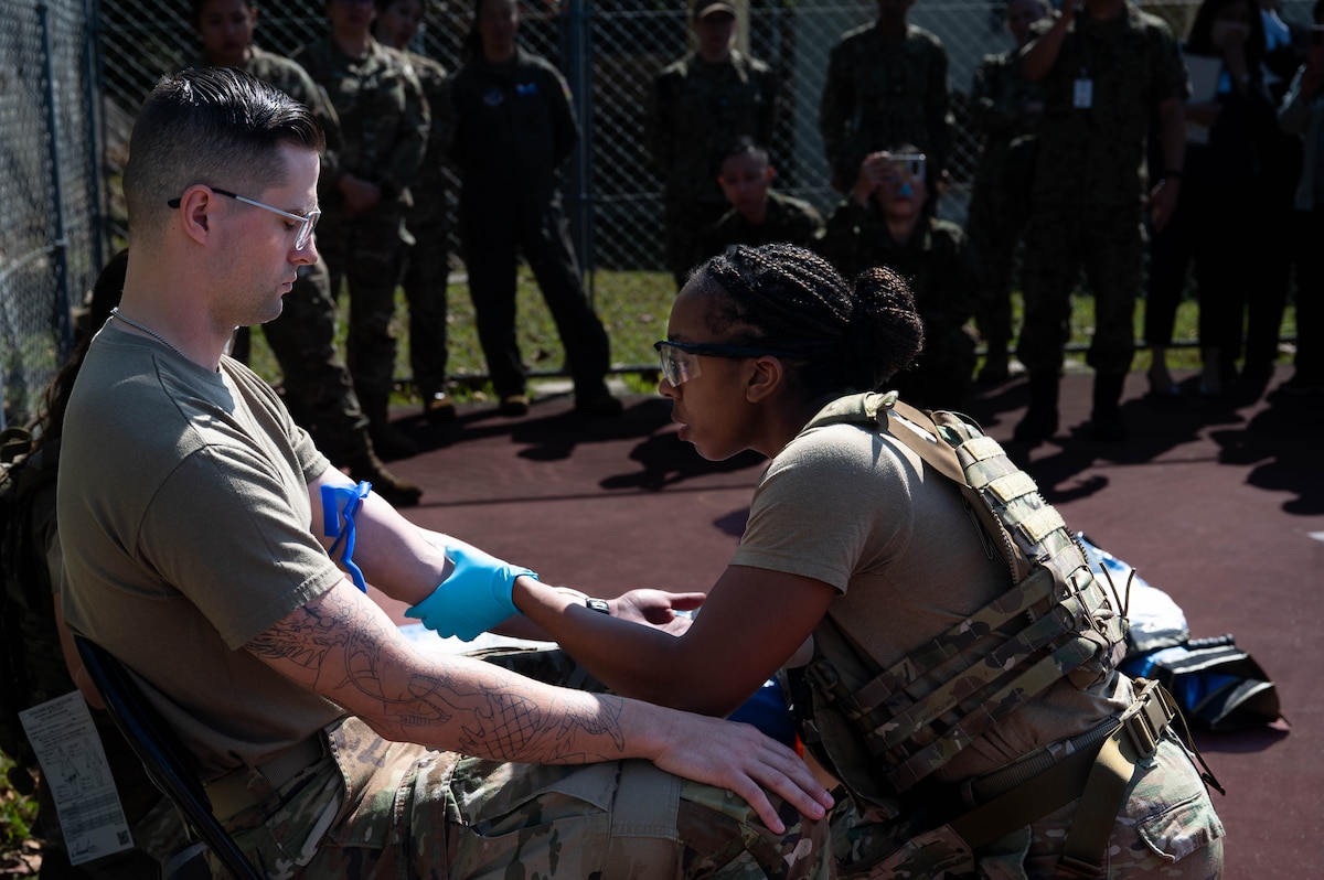 A nurse takes a blood sample from a patient