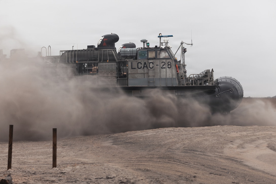 A U.S. Navy landing craft, air cushion with Assault Craft Unit 4 lands at Onslow Beach during Type Commander’s Amphibious Training 26.1 at Marine Corps Base Camp Lejeune, N.C., Feb. 27, 2026. TCAT is a military exercise designed to enhance mobility and integration between the U.S. Marine Corps and the U.S. Navy. It allows Marines and Sailors to gain hands-on experience of working side by side in amphibious planning and operations, including the use of multiple surface connectors and air platforms. The training focuses on improving the necessary skills for real-world operations and effective collaboration between Marine Corps and Naval teams. (U.S. Marine Corps photo by Sgt. Jorge Borjas)
