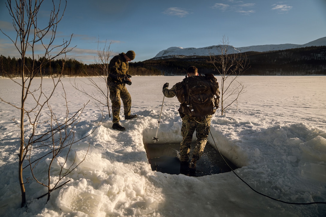 U.S. Marine Corps GySgt. Donato Maffin, a Communication Strategy and Operations chief with U.S. Marine Corps Forces, Europe and Africa, left, takes video of Sgt. Noah Masog, a combat videographer with U.S. Marine Corps Forces, Europe and Africa, conducting the cold plunge in Setermoen, Norway, Mar. 2, 2026. The cold plunge is a part of the cold weather training that is conducted by NATO partners and allies in preparation for exercise Cold Response 26. A key component of NATO's enhanced vigilance activity Arctic Sentry, exercise Cold Response 26 is a Norwegian-led winter military exercise designed to enhance collective defense capabilities and ensure U.S. readiness to rapidly deploy and seamlessly operate alongside NATO Allies in challenging arctic conditions. (U.S. Marine Corps photo by Sgt. Noah Masog)