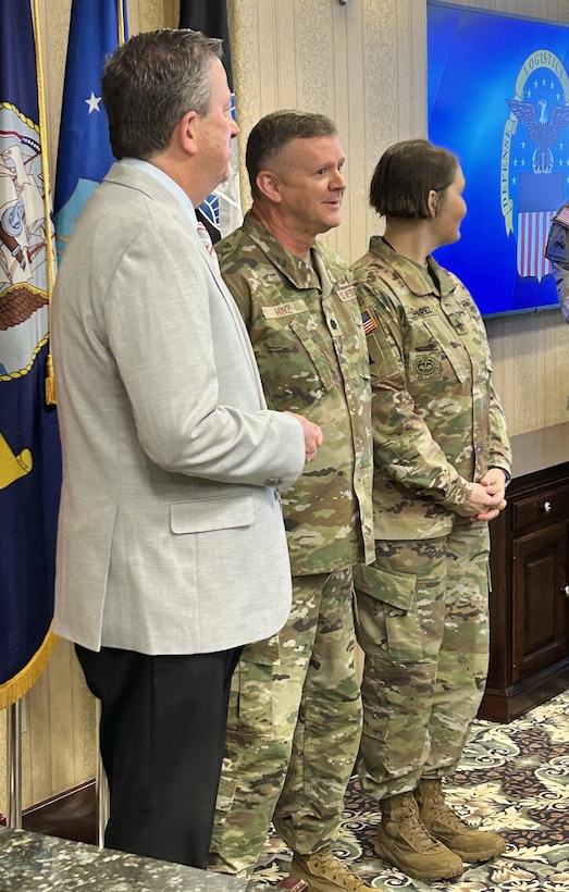 DLA Vice Director Brad Bunn presents Air Force Lt. Col. Michael Hinz with a Vice Director’s Coin before a DLA Disposition Services Annual Operating Plan update Feb. 27.