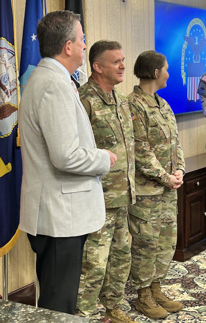 DLA Vice Director Brad Bunn presents Air Force Lt. Col. Michael Hinz with a Vice Director’s Coin before a DLA Disposition Services Annual Operating Plan update Feb. 27.