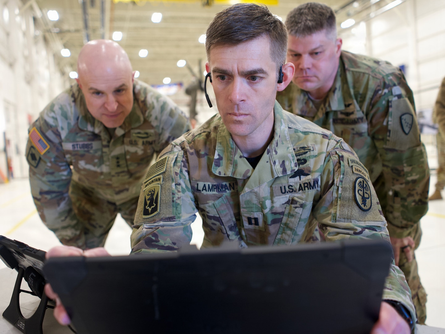 U.S. Army Capt. Peter Lampman, center, a general surgery resident at Oregon Health and Science University, and Alaska Army National Guard Maj. Titus Rund, right, 207th Aviation Troop Command flight surgeon, demonstrate the Augmented Reality TeleMentor system for Lt. Gen. Jon Stubbs, director of the Army National Guard, Feb. 20, 2026, at Joint Base Elmendorf-Richardson.