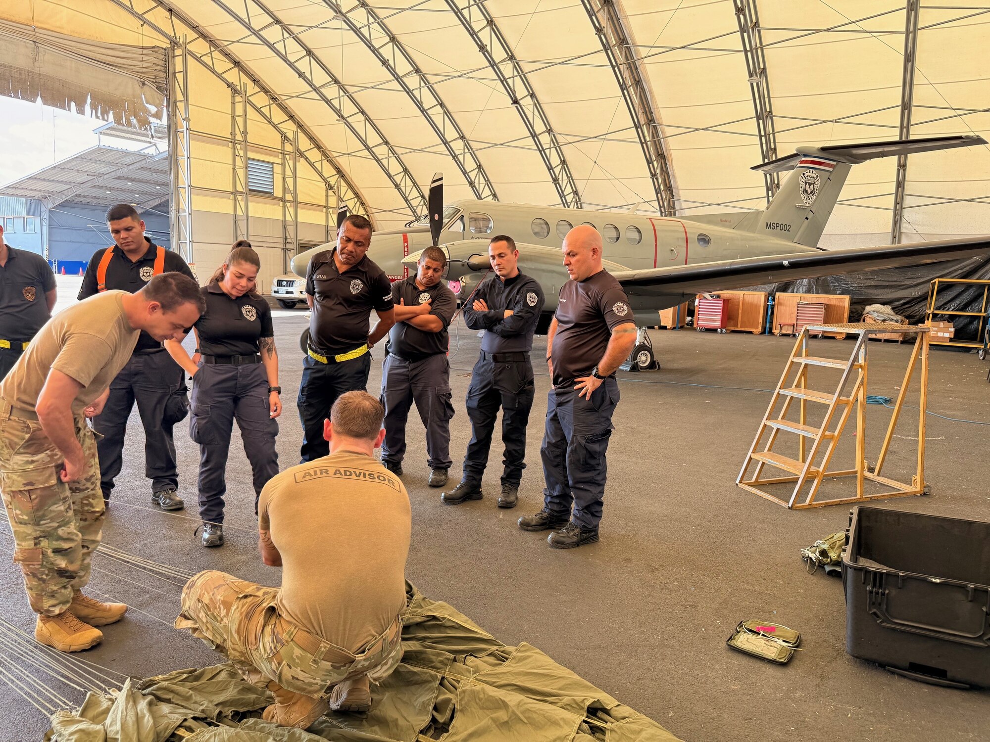 People view a parachute demonstration.
