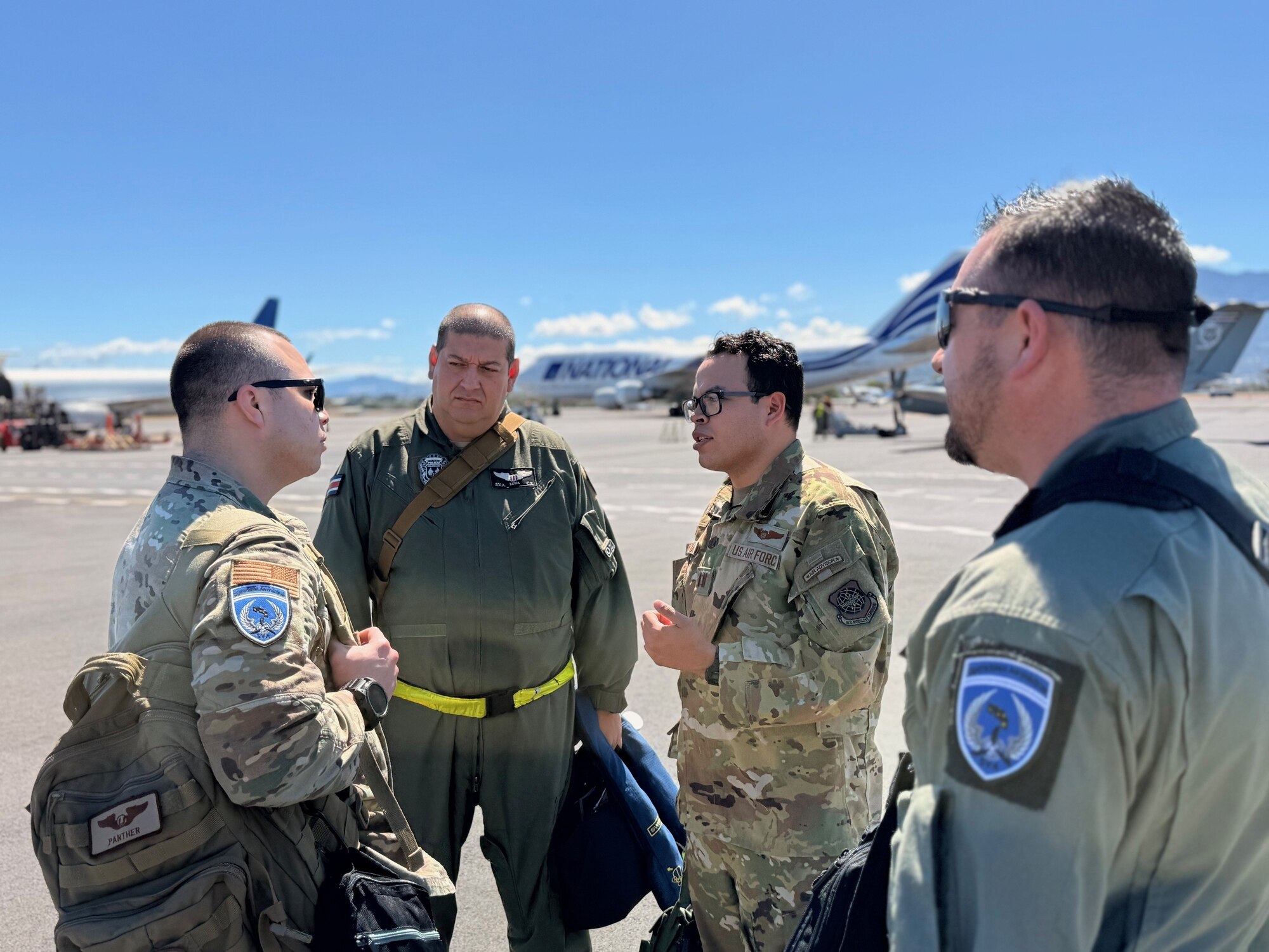 Men talk on flightline.
