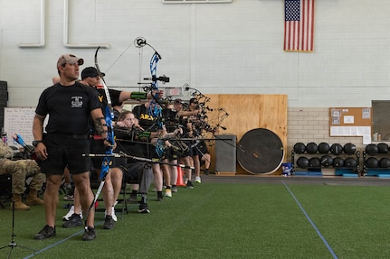 The second group of competitors takes practice shots during an archery competition March 3, 2026, at the Ronald D. Milam Physical Fitness Center at Fort Bliss, Texas.