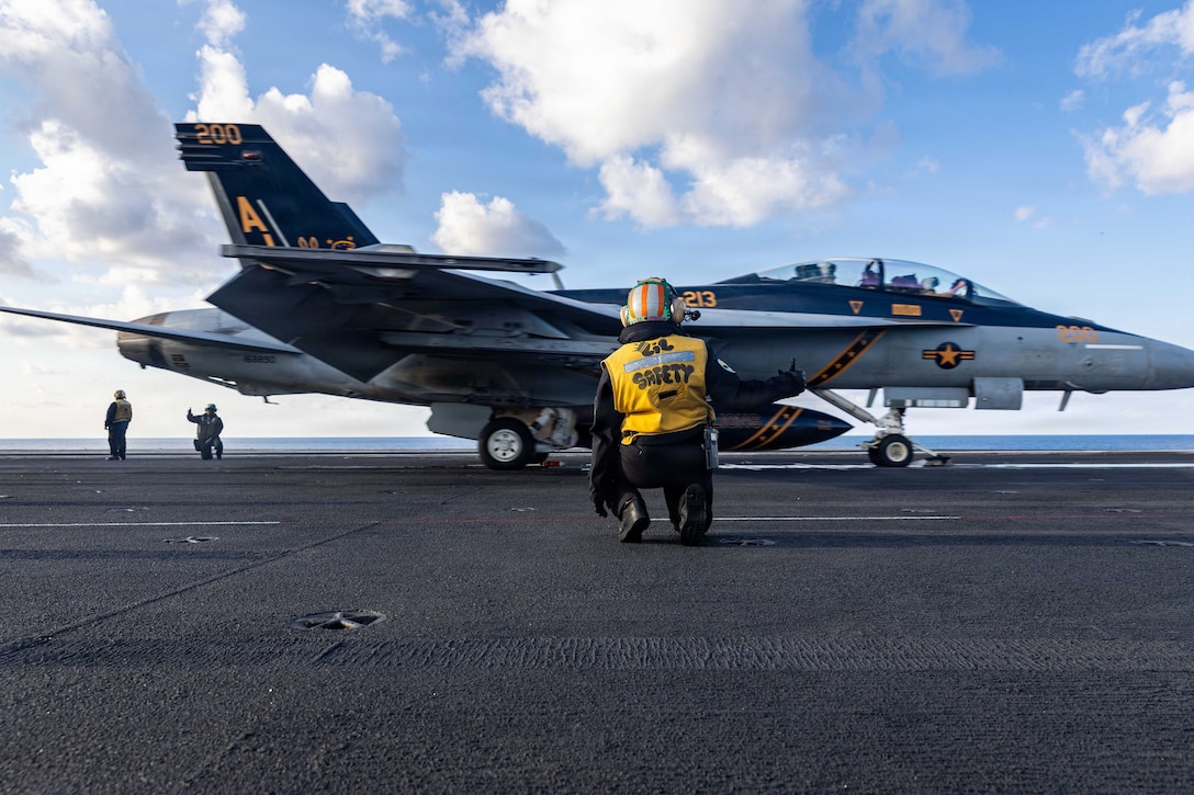 A U.S. Sailor signals to launch a F/A-18F Super Hornet, attached to Strike Fighter Squadron 213, on the flight deck of the world’s largest aircraft carrier, USS Gerald R. Ford (CVN 78), while operating in support of Operation Epic Fury in the Eastern Mediterranean Sea, March 2, 2026. (U.S. Navy photo)