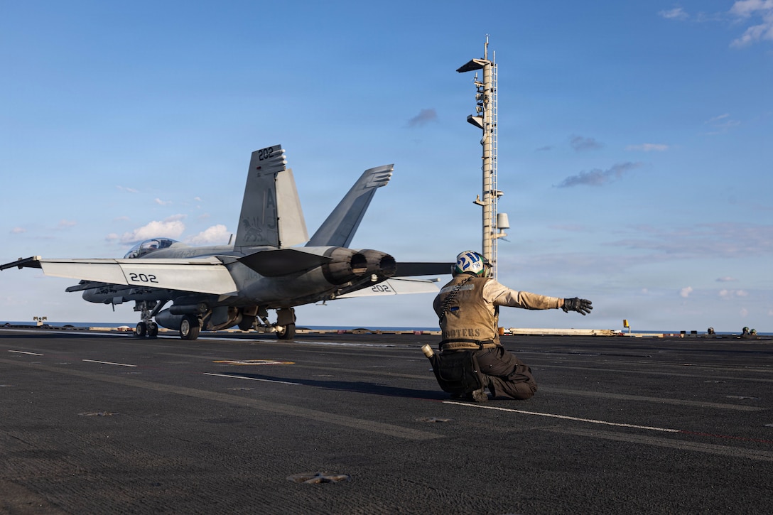 A U.S. Sailor signals the launch of an F/A-18F Super Hornet aircraft, attached to Strike Fighter Squadron 213, from the flight deck of the world’s largest aircraft carrier, USS Gerald R. Ford (CVN 78), while operating in support of Operation Epic Fury in the Eastern Mediterranean Sea, March 2, 2026. (U.S. Navy photo)