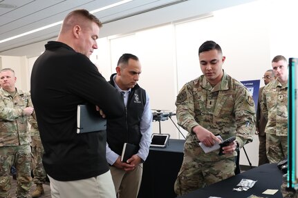 1st Lt. Justin Hanna, U.S. Air Force CBRN Systems Branch, demonstrates the Colorimetric Indicator (CIND) for Maj. Gen. Christopher Beck and CSM Jorge Arzabala, PAE LP & CBRND as a part of the “avoid being hit” portion of formation based layered protection during a visit to CPE CBRND.