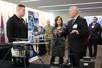 Army Maj. Gen. Christopher Beck (left), PAE LP & CBRND and Ms. Nicole Kilgore, CPE CBRND learn about CBRN Sensor Integrated on Robotics Platform (CSIRP), a part of the “avoid being hit” portion of formation based layered protection, during a visit to CPE CBRND.