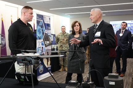 Army Maj. Gen. Christopher Beck (left), PAE LP & CBRND and Ms. Nicole Kilgore, CPE CBRND learn about CBRN Sensor Integrated on Robotics Platform (CSIRP), a part of the “avoid being hit” portion of formation based layered protection, during a visit to CPE CBRND.
