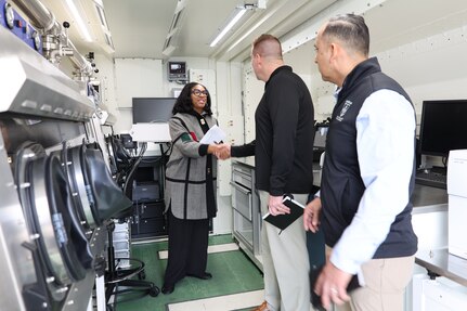 Kia Hopkins, CPE CBRND, demonstrates the Analytical Laboratory System (ALS) for Maj. Gen. Christopher Beck and CSM Jorge Arzabala, PAE LP & CBRND as a part of the “survive if hit” portion of formation based layered protection during a visit to CPE CBRND. Photo Credit: Vashelle Nino, CPE CBRND
