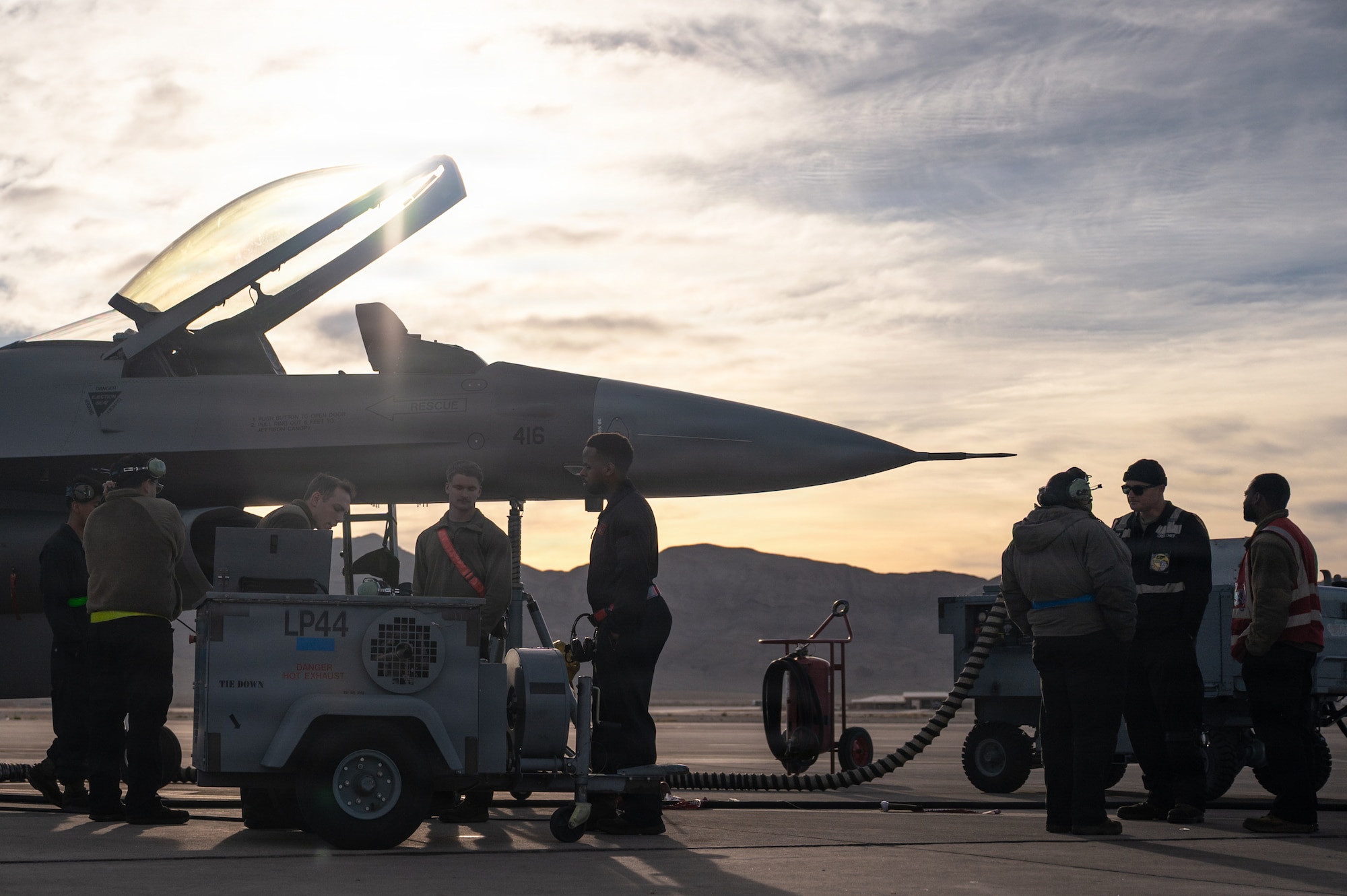 people stand next to a jet