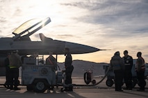 people stand next to a jet