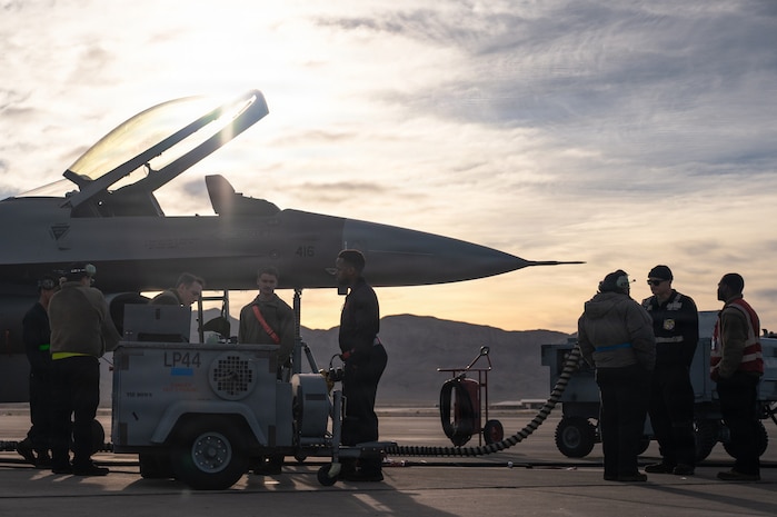people stand next to a jet