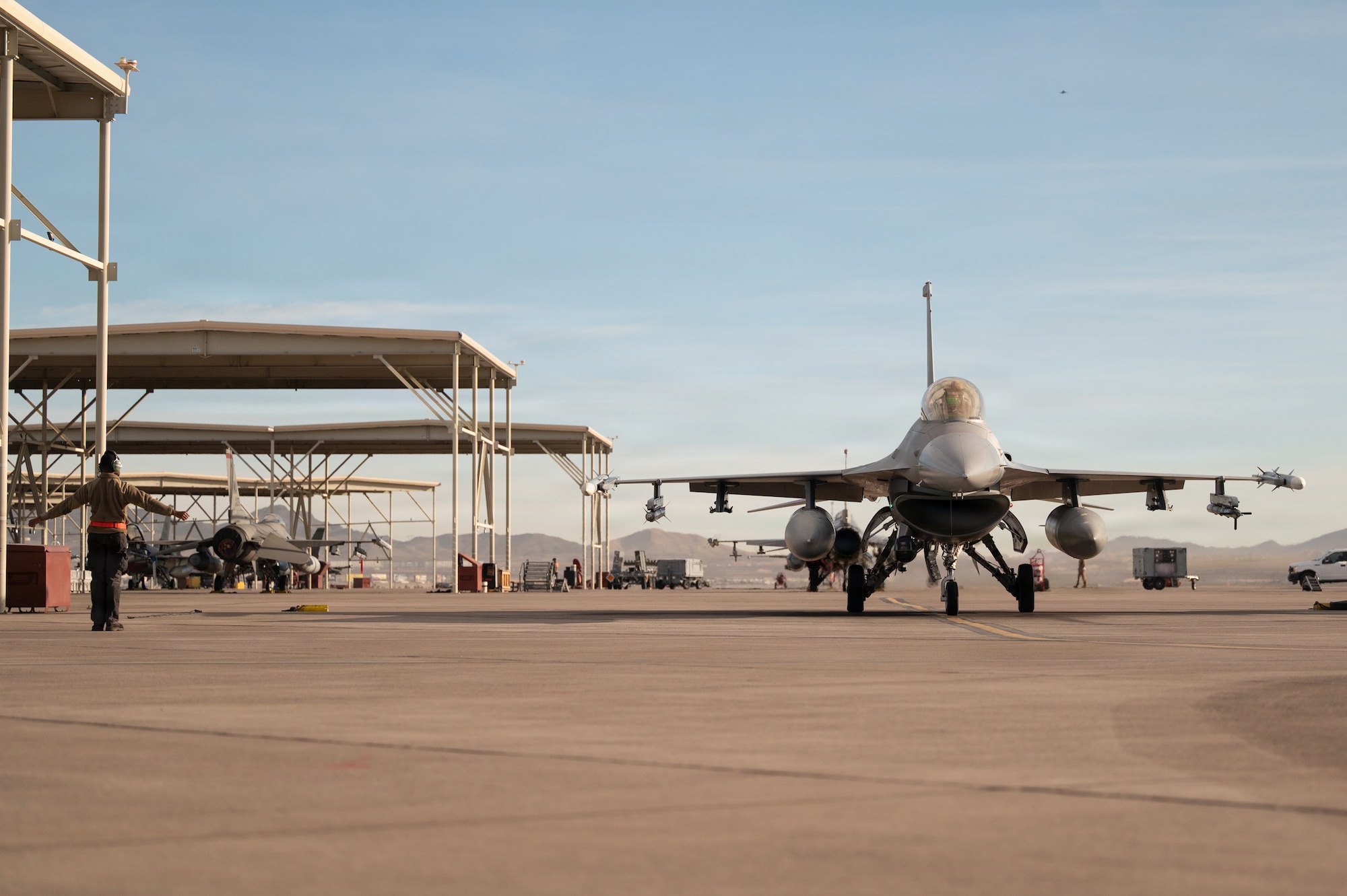 a person stands in front of a jet