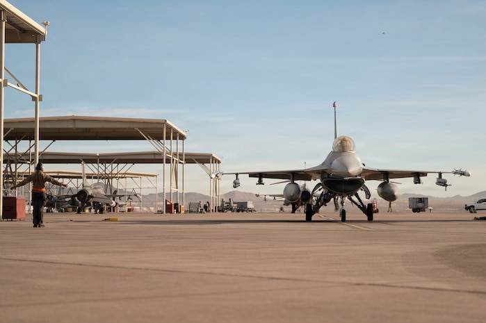 a person stands in front of a jet