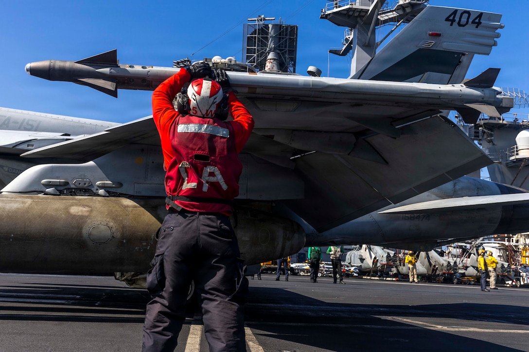 A U.S. Sailor checks ordinance on an F/A-18E Super Hornet, attached to Strike Fighter Squadron (VFA) 151, on the flight deck of Nimitz-class aircraft carrier USS Abraham Lincoln (CVN 72) in support of Operation Epic Fury, Mar. 3, 2026.  (U.S. Navy photo)